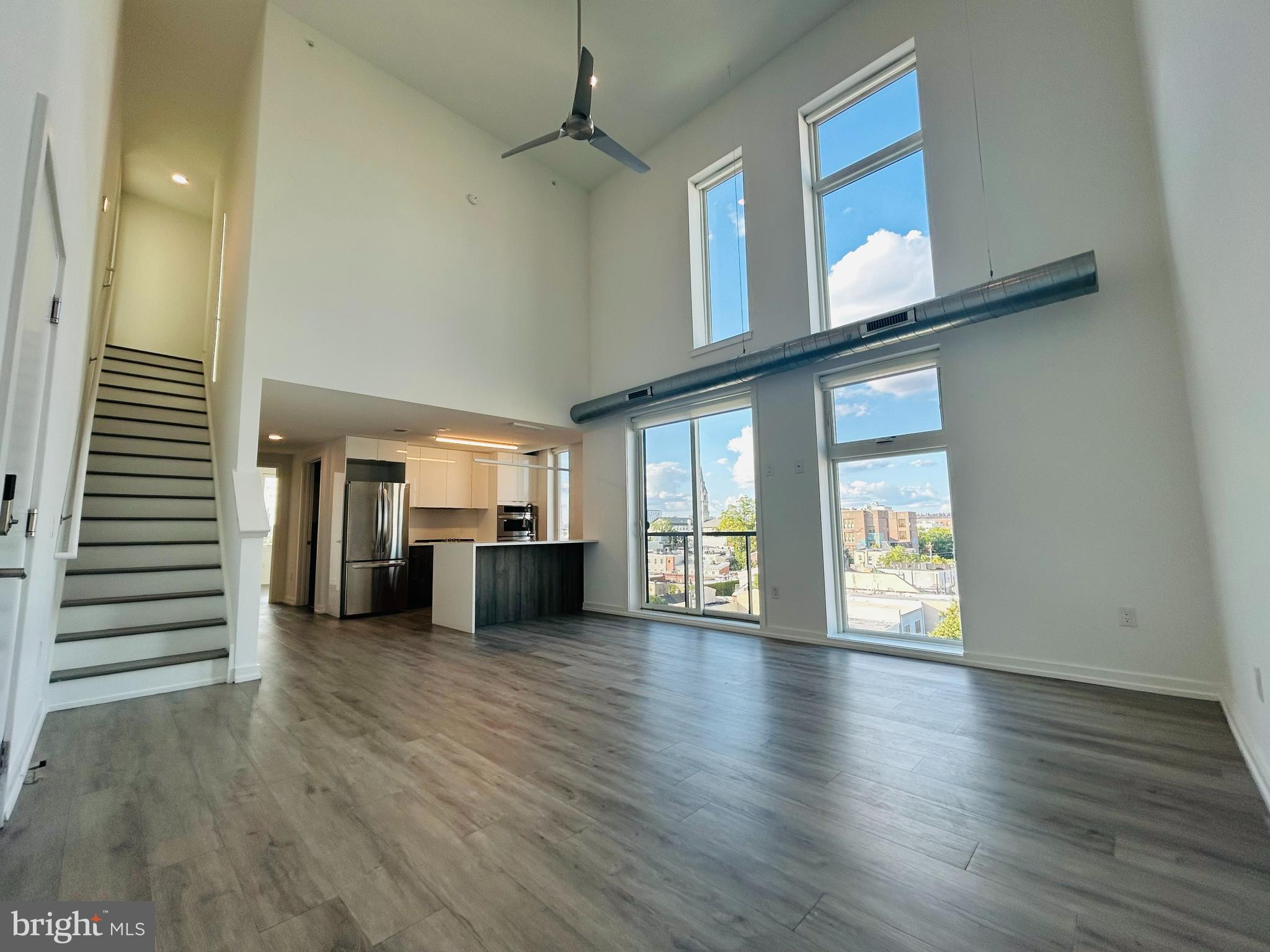 a view of a kitchen with furniture and wooden floor