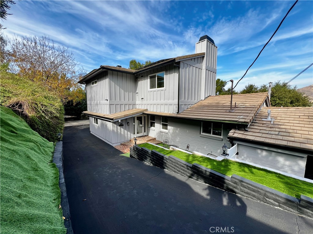 a backyard of a house with yard and outdoor seating