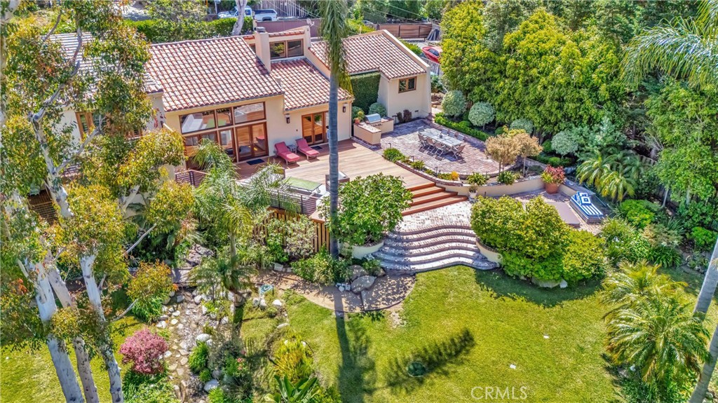 an aerial view of residential houses with yard and swimming pool