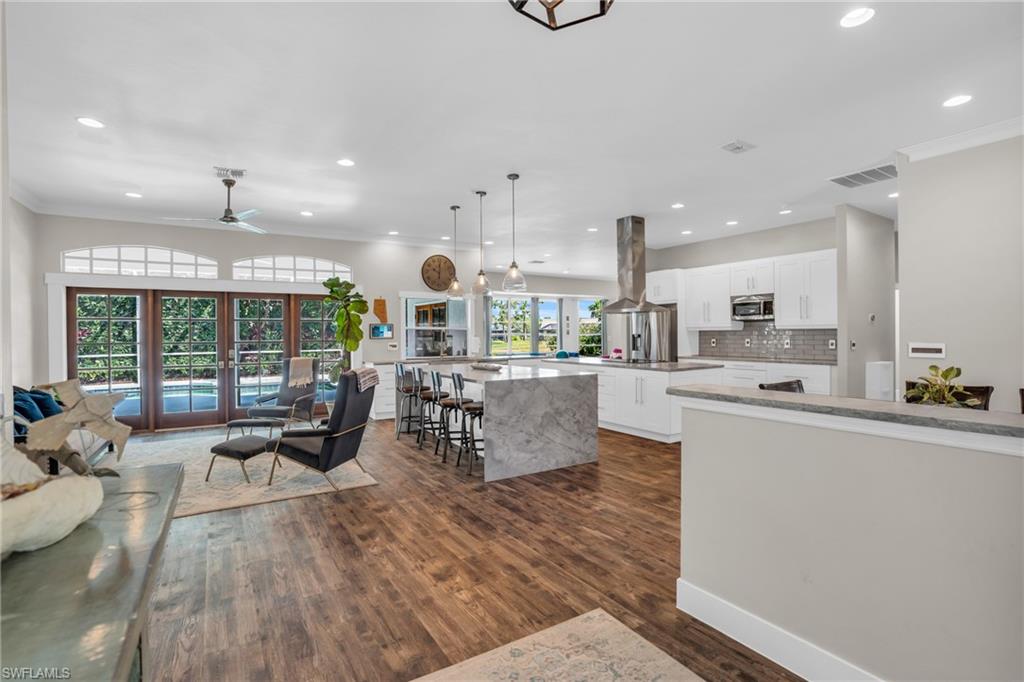 a living room with kitchen island furniture and a large window