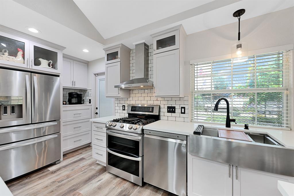 a kitchen with stainless steel appliances a stove sink and refrigerator