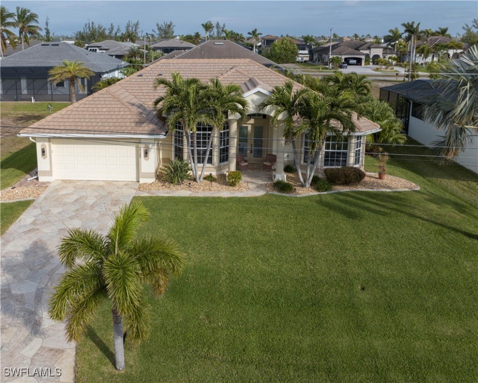 an aerial view of a house with swimming pool and a yard