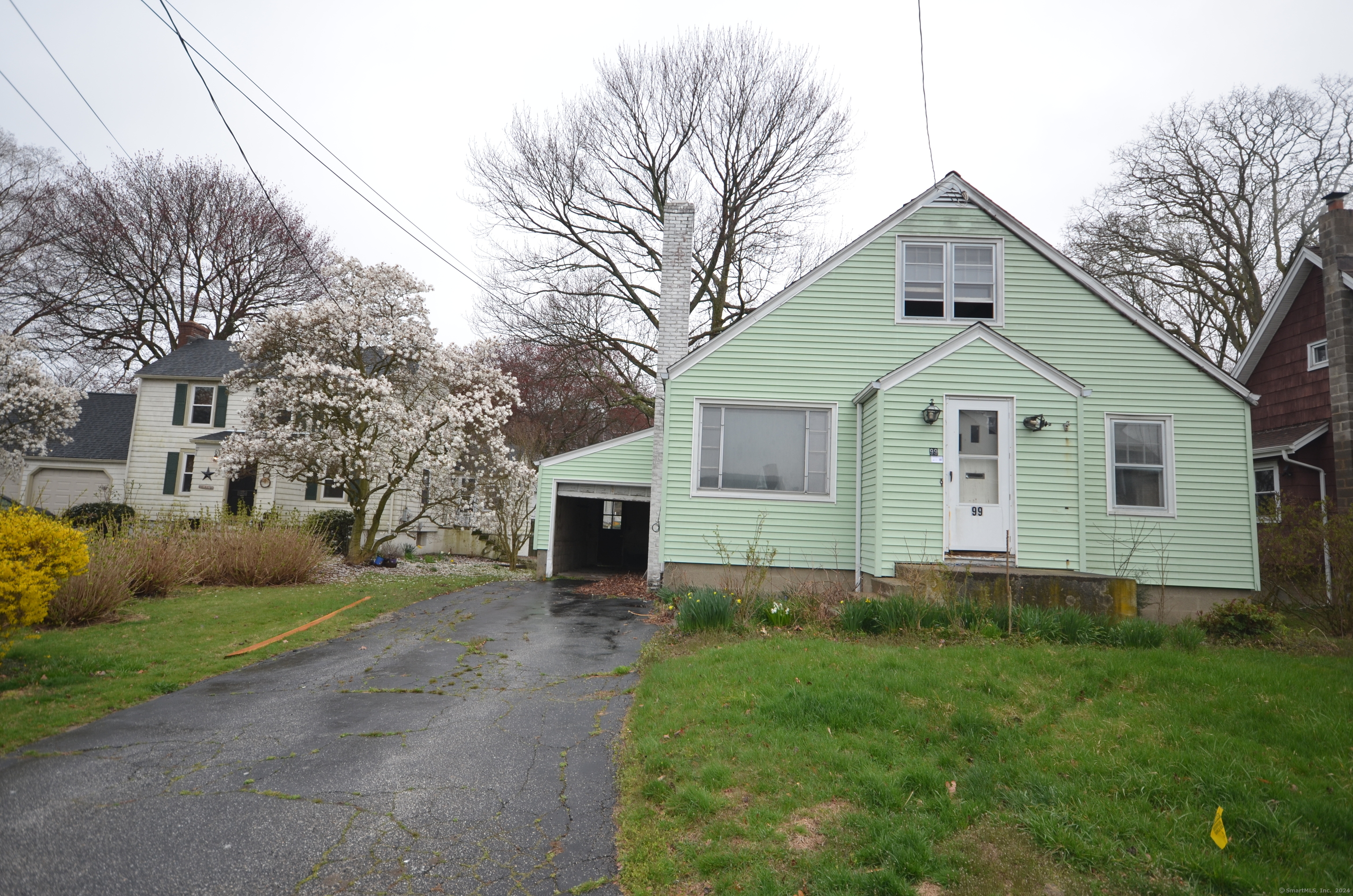 a front view of house with yard and trees