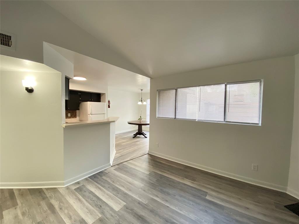 a view of kitchen with wooden floor and electronic appliances