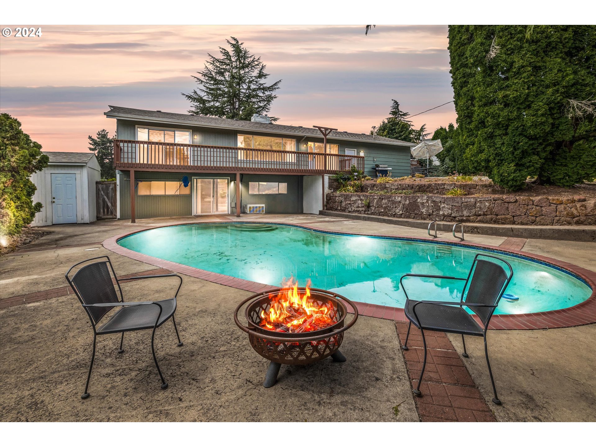 a swimming pool with outdoor seating and yard