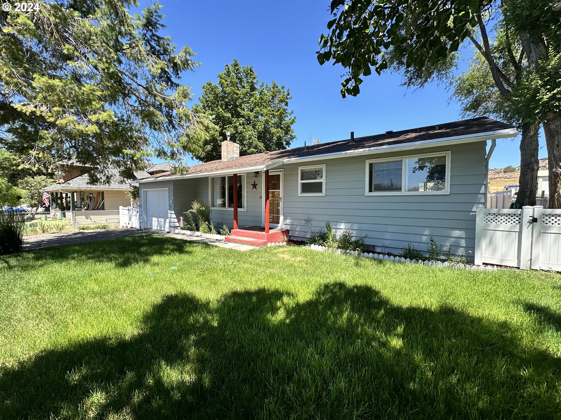 a front view of house with yard and green space