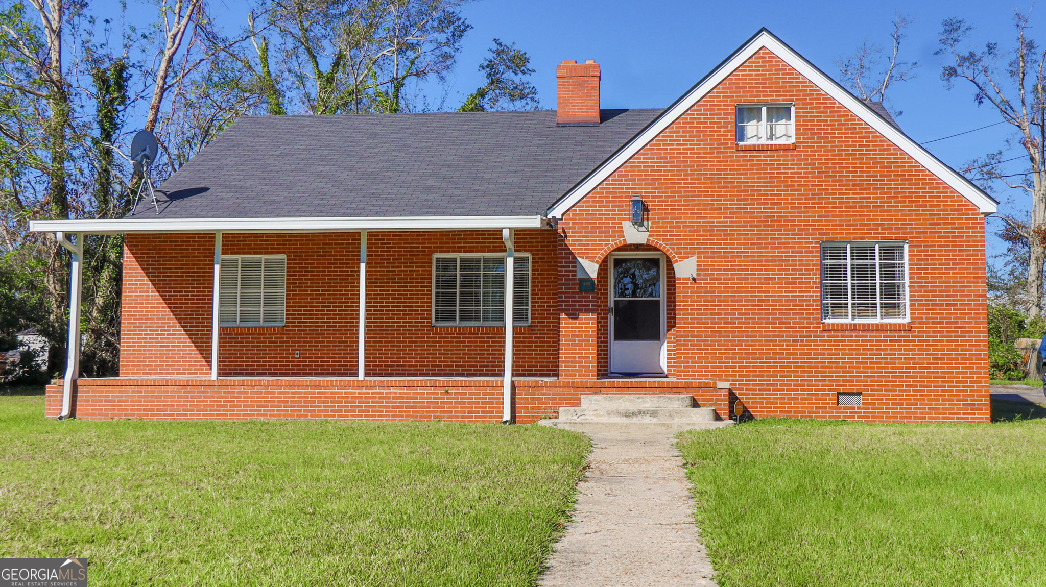 a front view of a house with garden