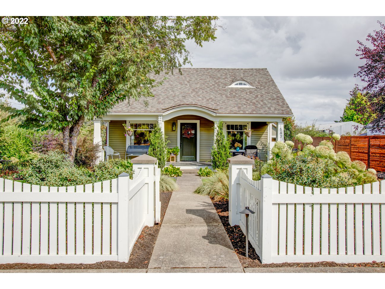 a front view of house with yard seating and green space