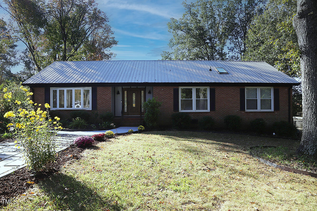 a view of house with yard