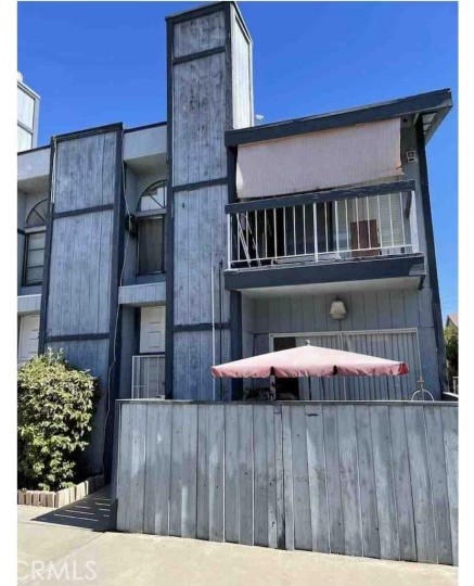 a dinning table and chairs in front of a house