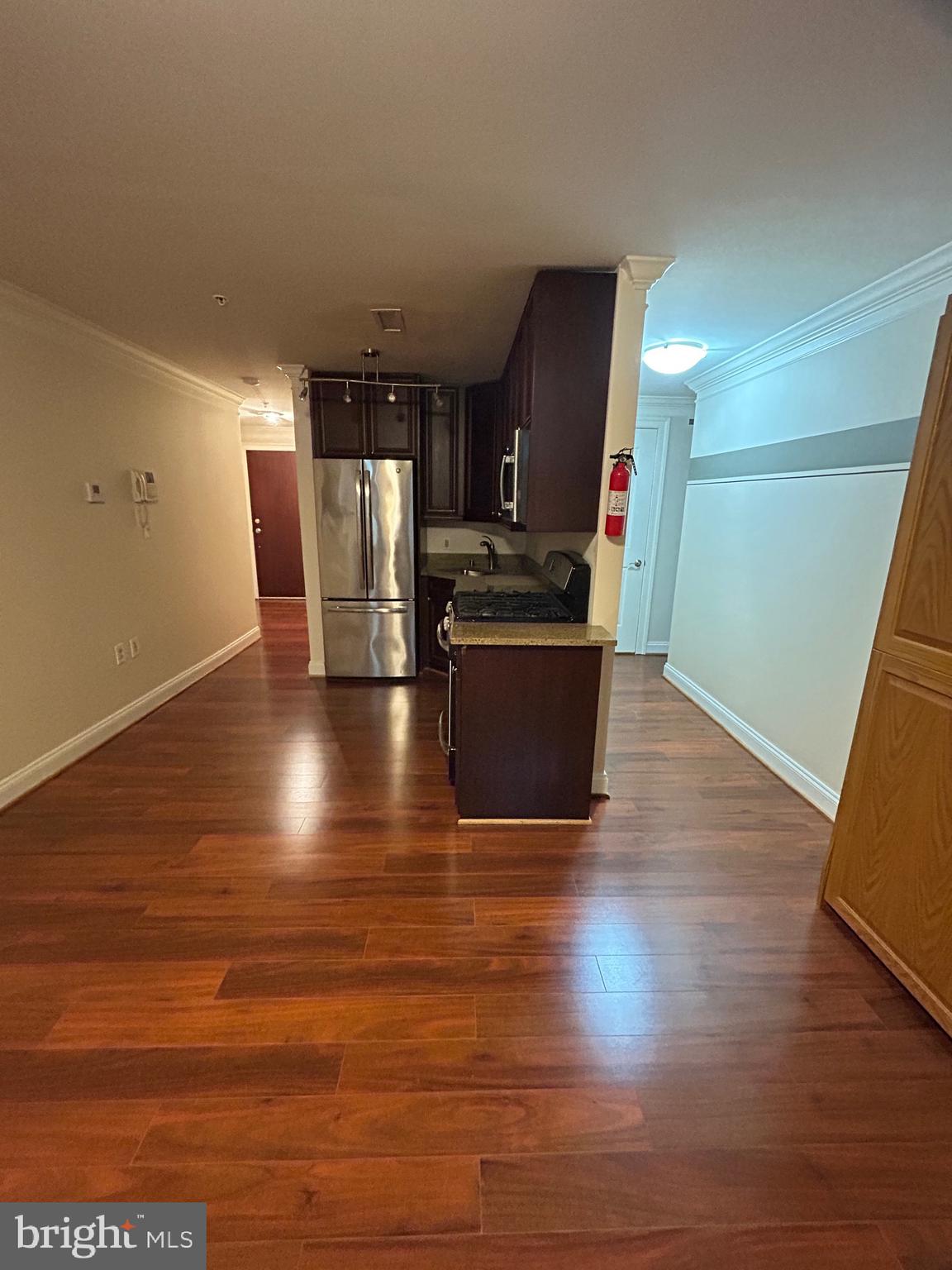 a view of kitchen with cabinets and wooden floor