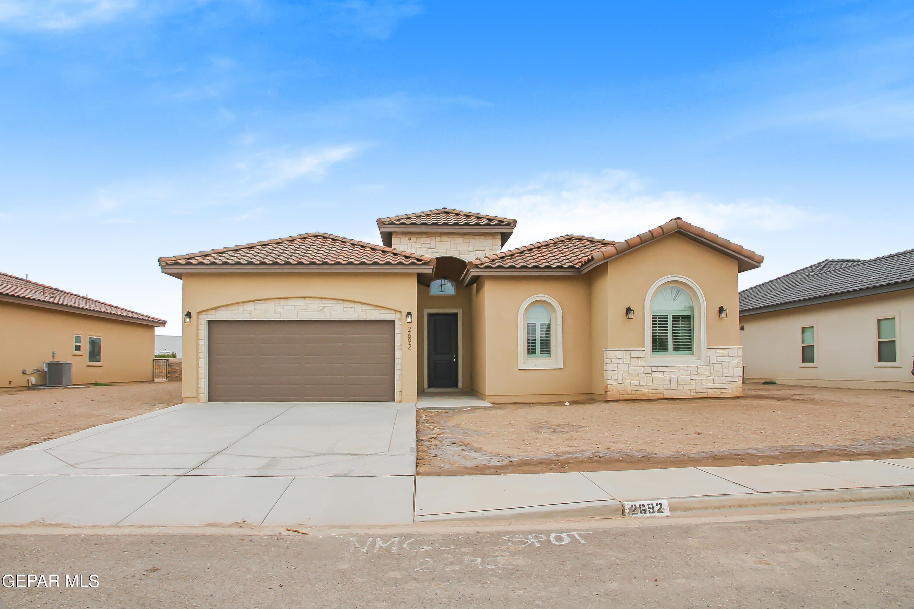 a front view of a house with a garage