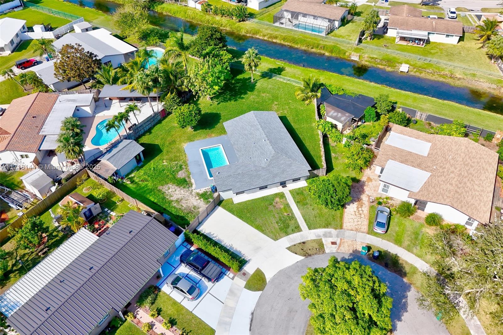 an aerial view of a house with a garden and swimming pool