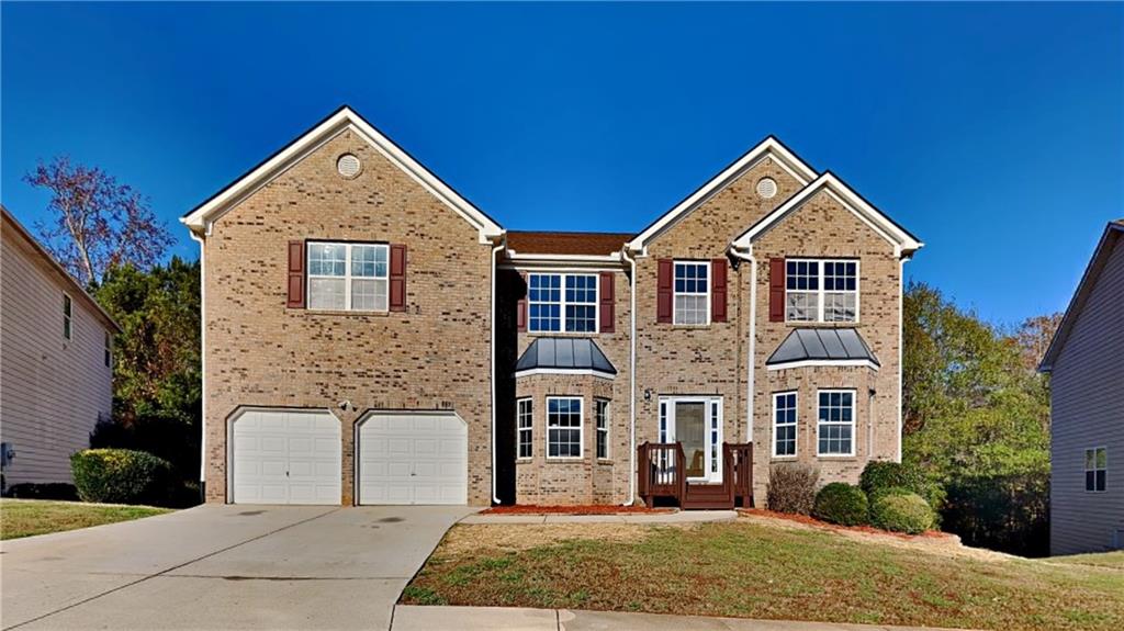 a front view of a house with a yard