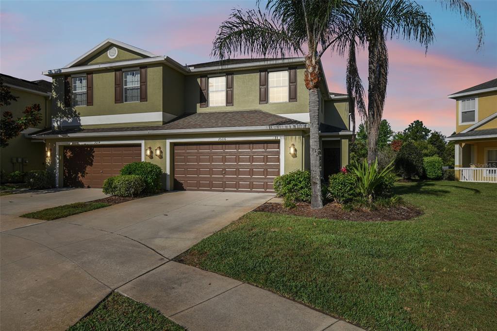 a front view of a house with a yard and garage