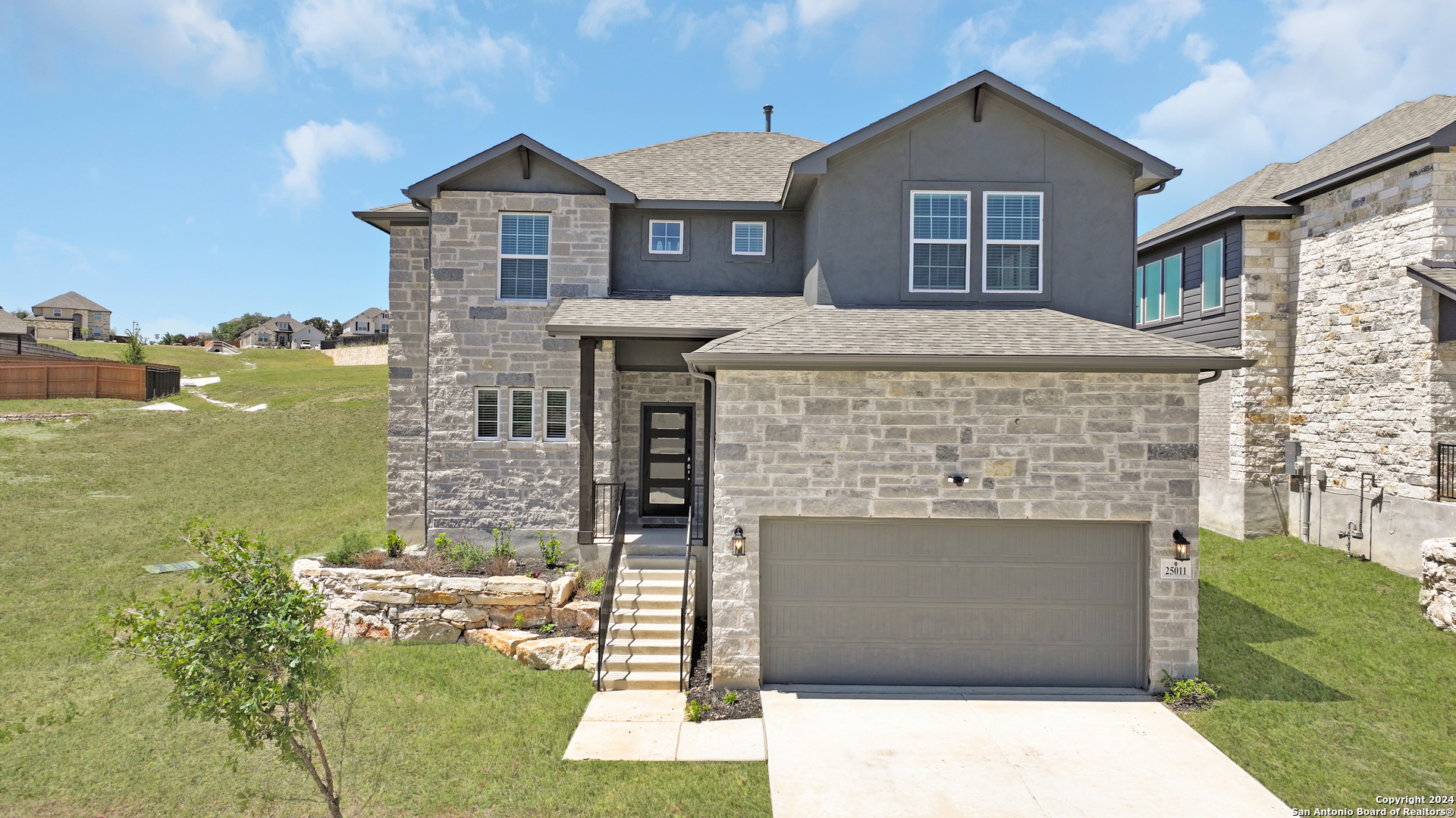 a front view of a house with a yard