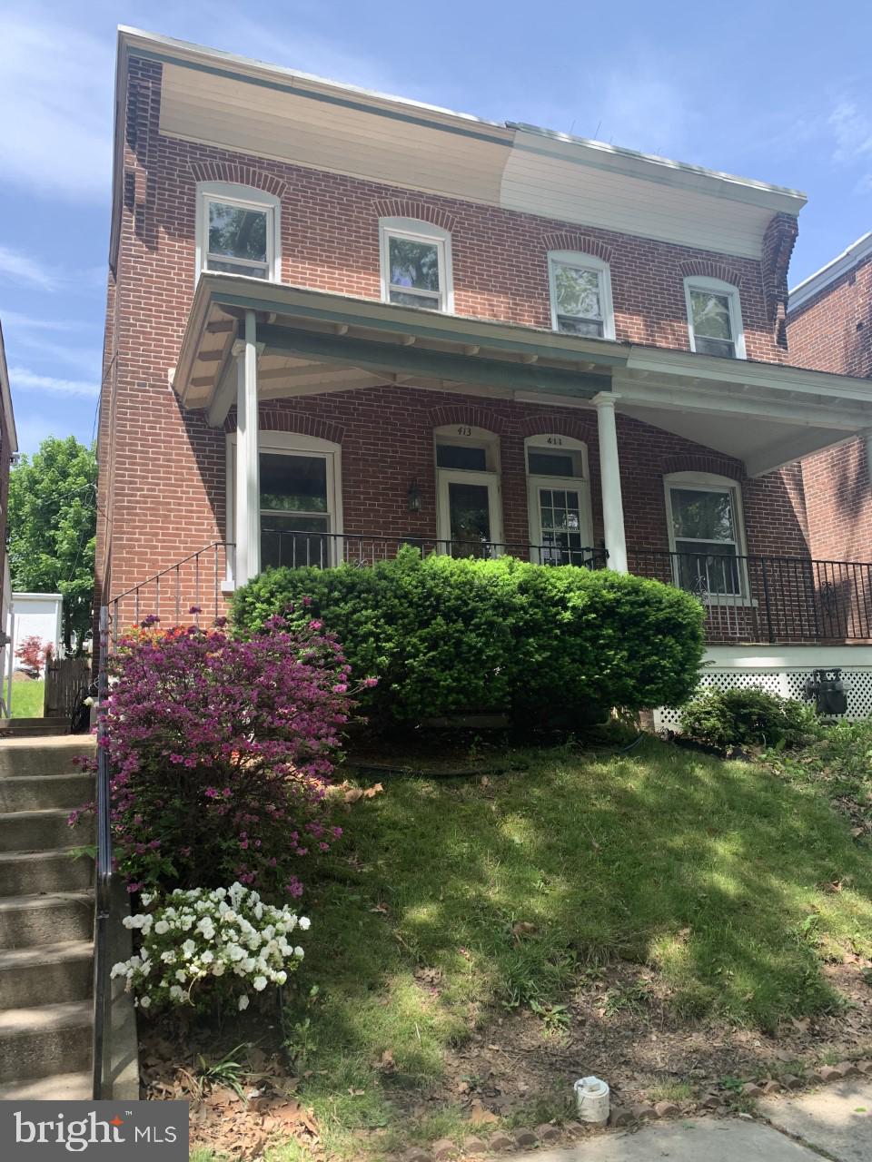 front view of a house with a garden