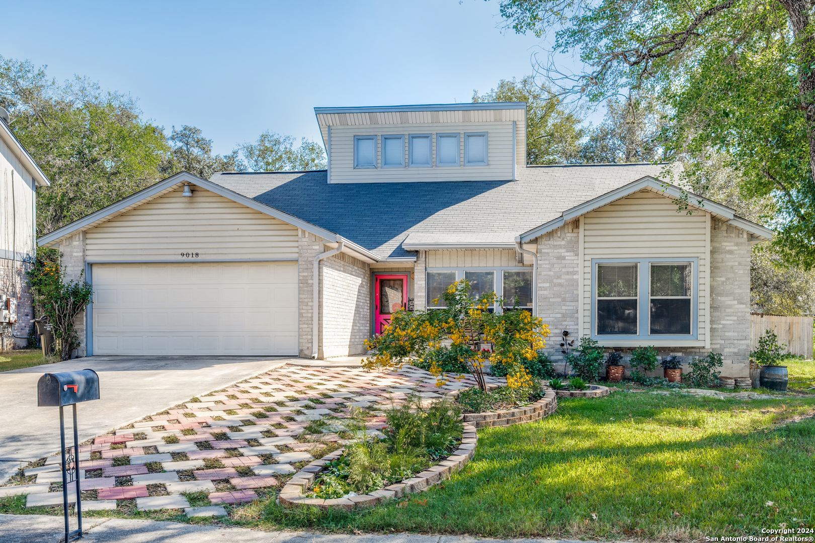 a front view of a house with garden