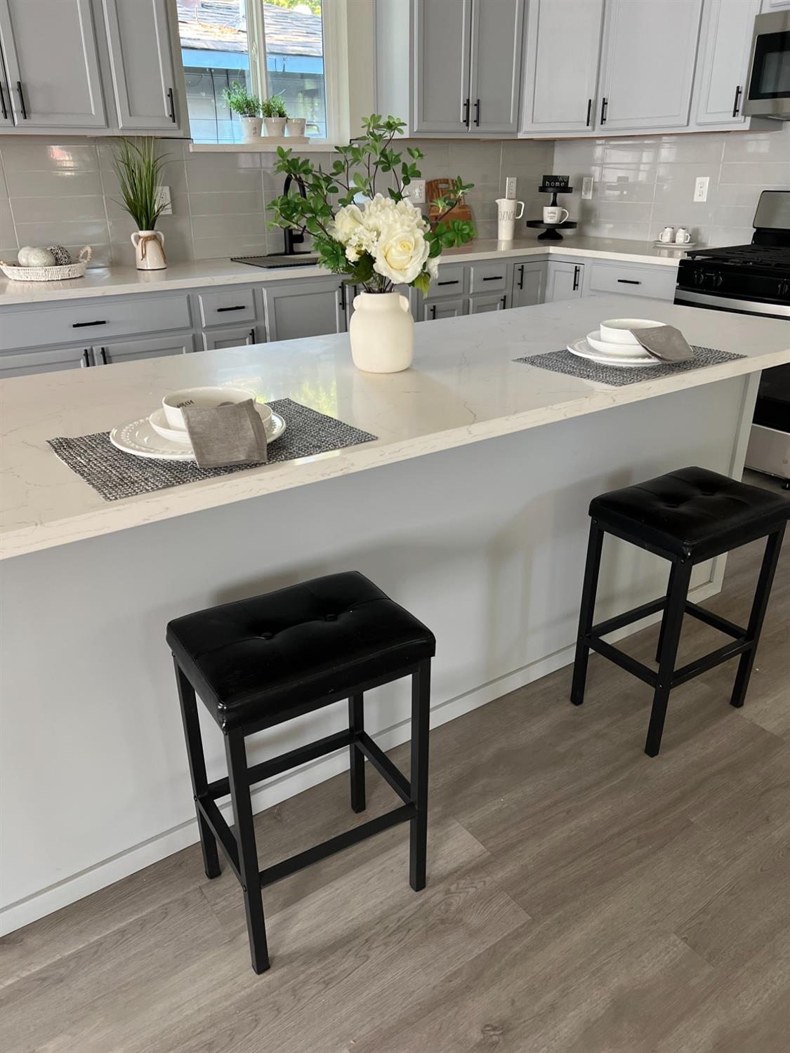 a kitchen with a sink and a potted plant