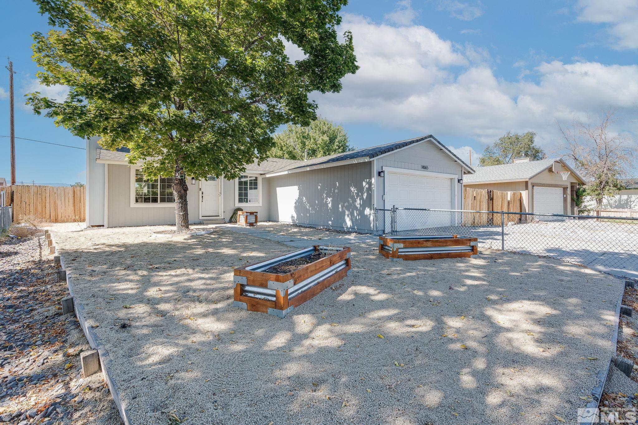 a backyard of a house with barbeque oven table and chairs