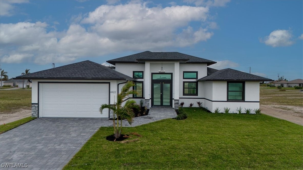 a view of a house with a yard and sitting area