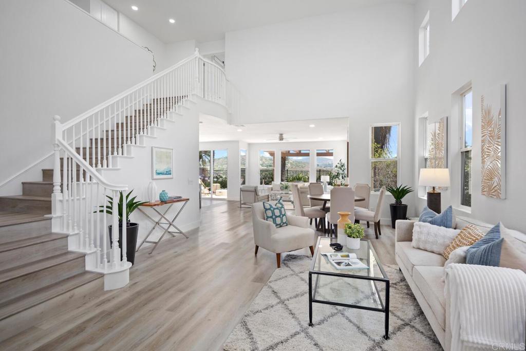 a living room with furniture and a table with wooden floor