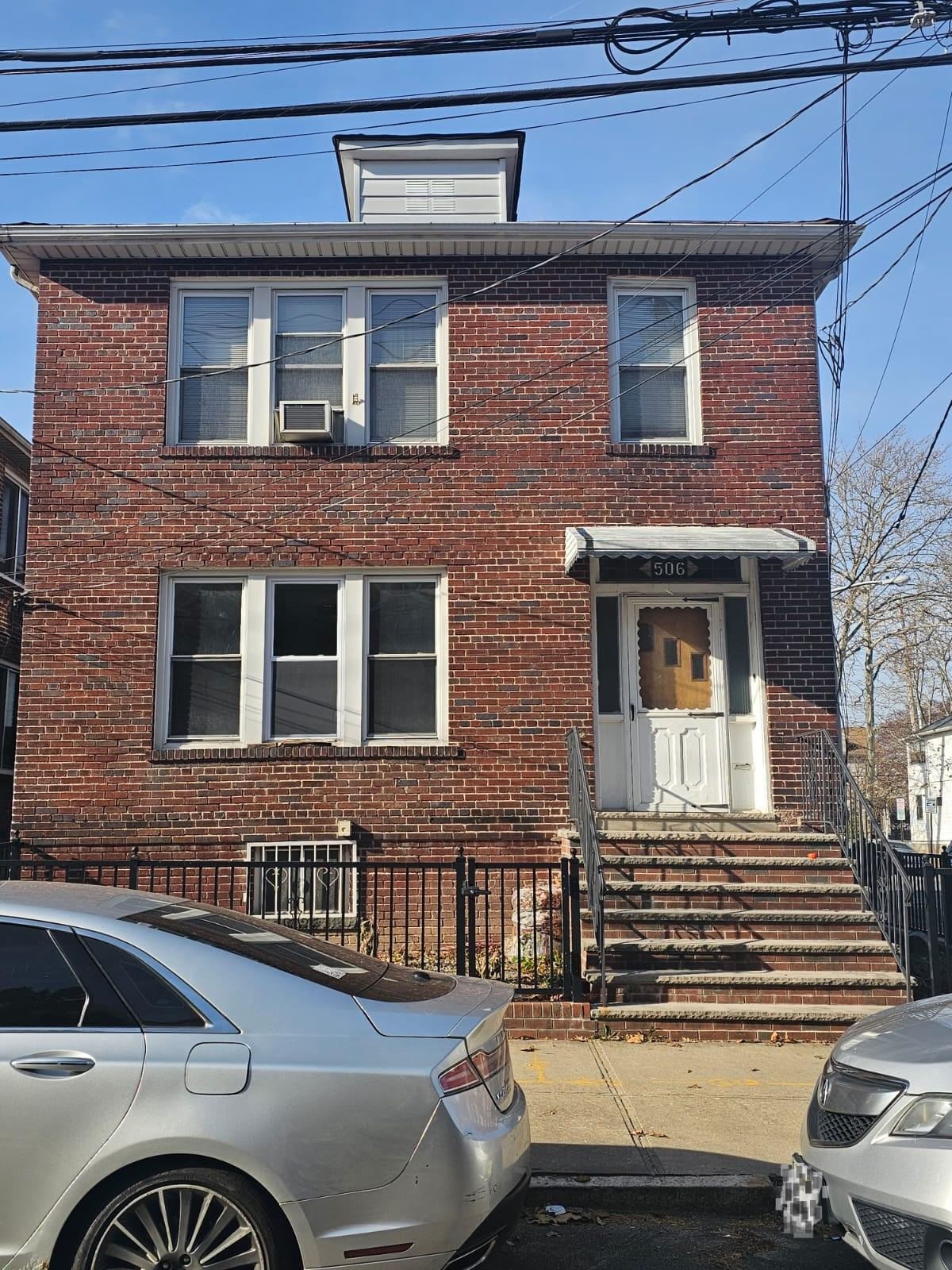 a front view of a house with a parking space