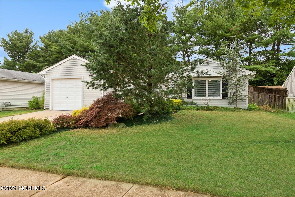 a front view of house with yard and green space