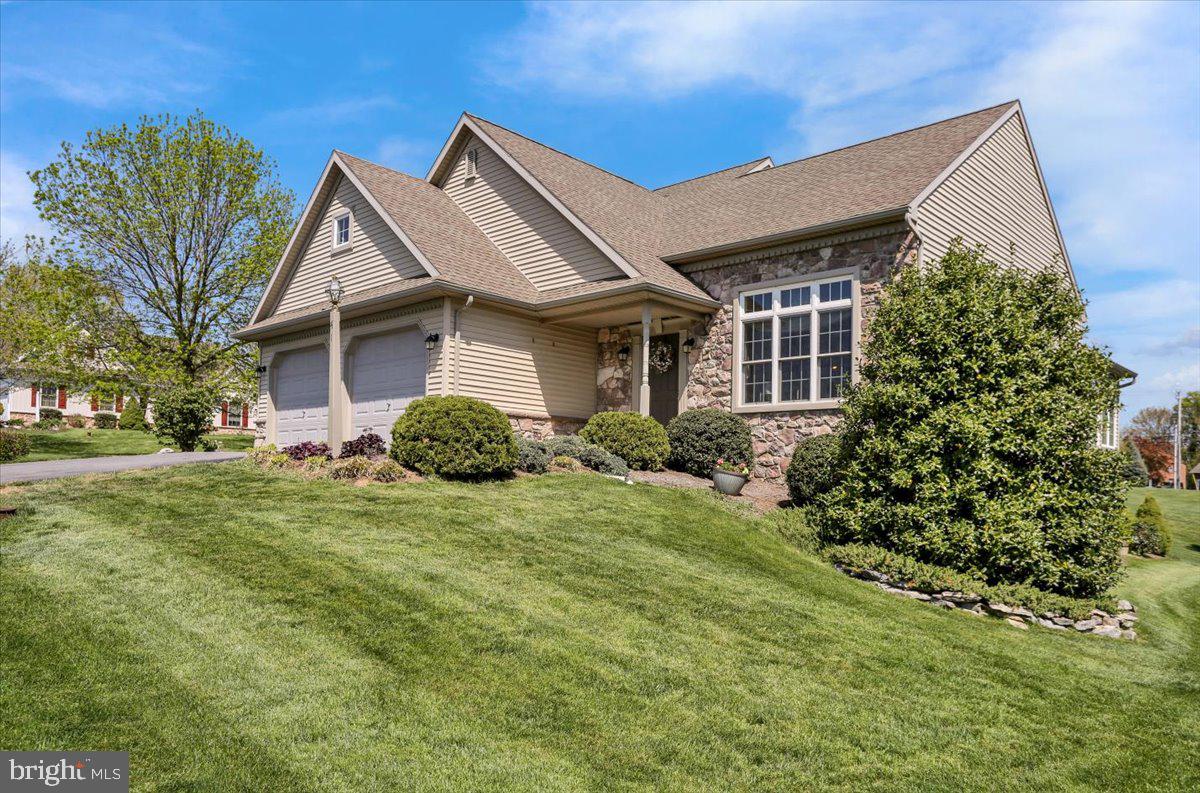 a front view of a house with a garden