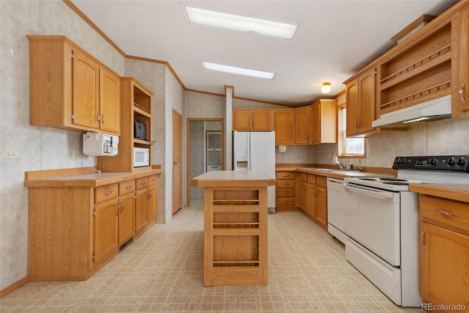 a kitchen with stainless steel appliances granite countertop a stove and cabinets