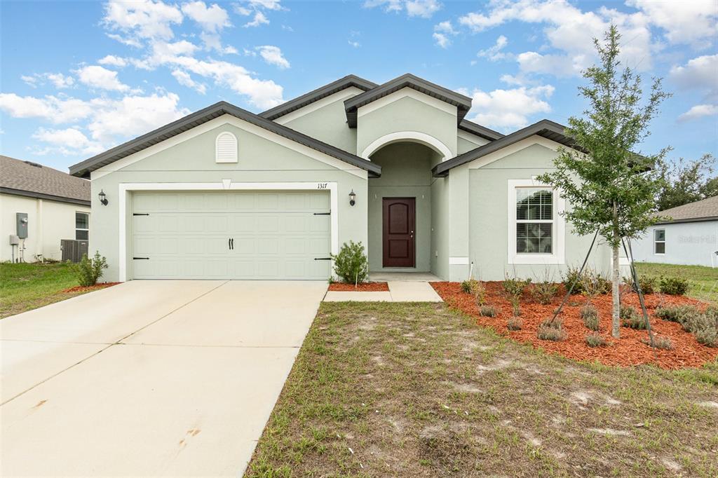 a front view of a house with a yard