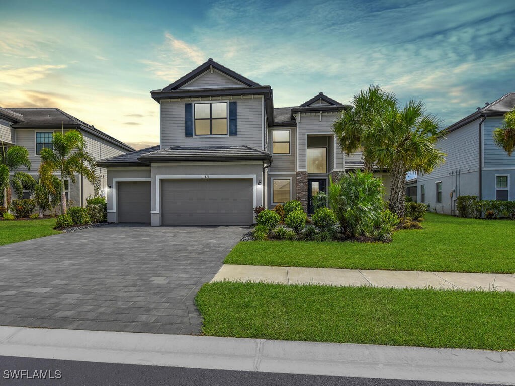 a front view of a house with a yard and garage