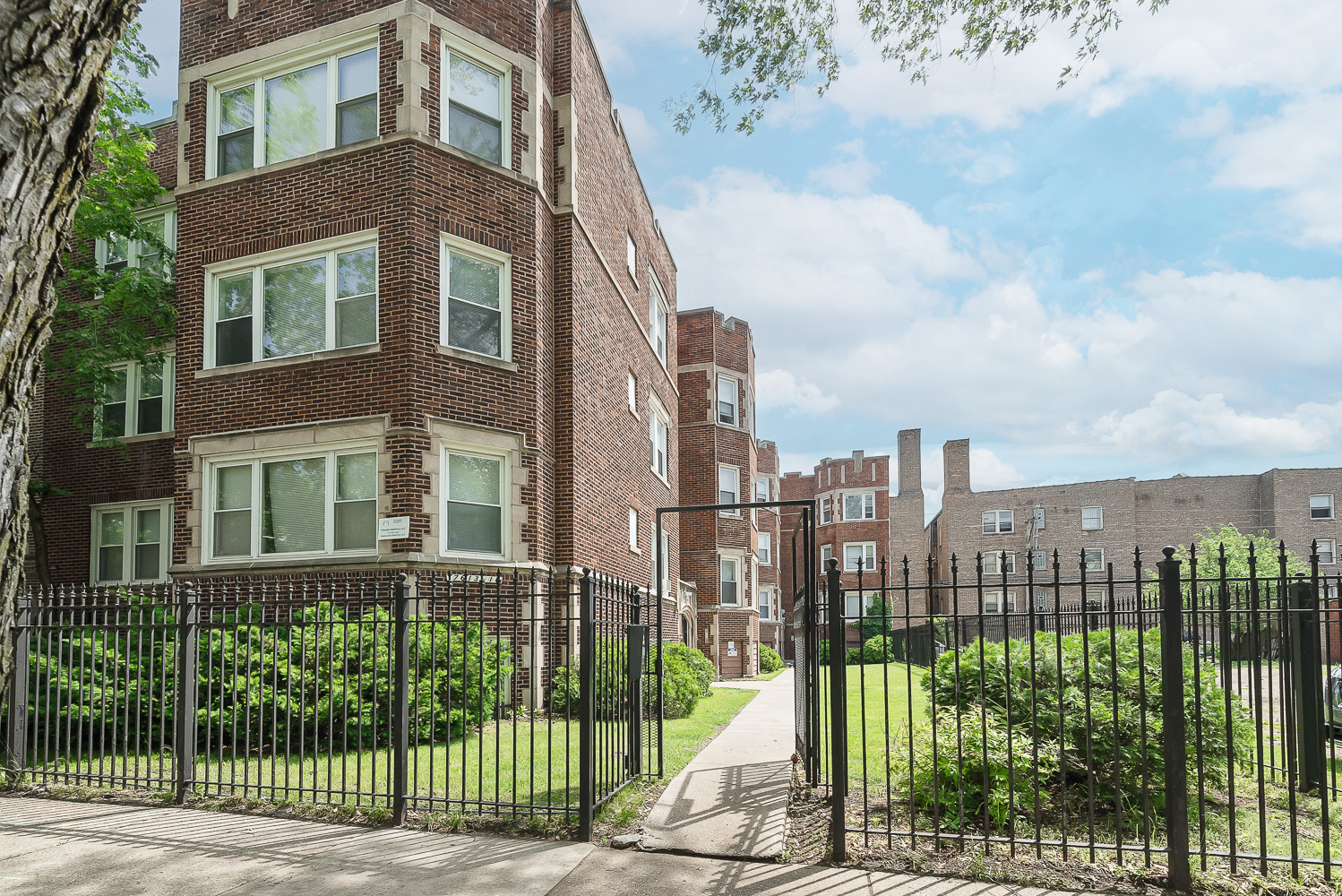 a view of a brick building next to a yard