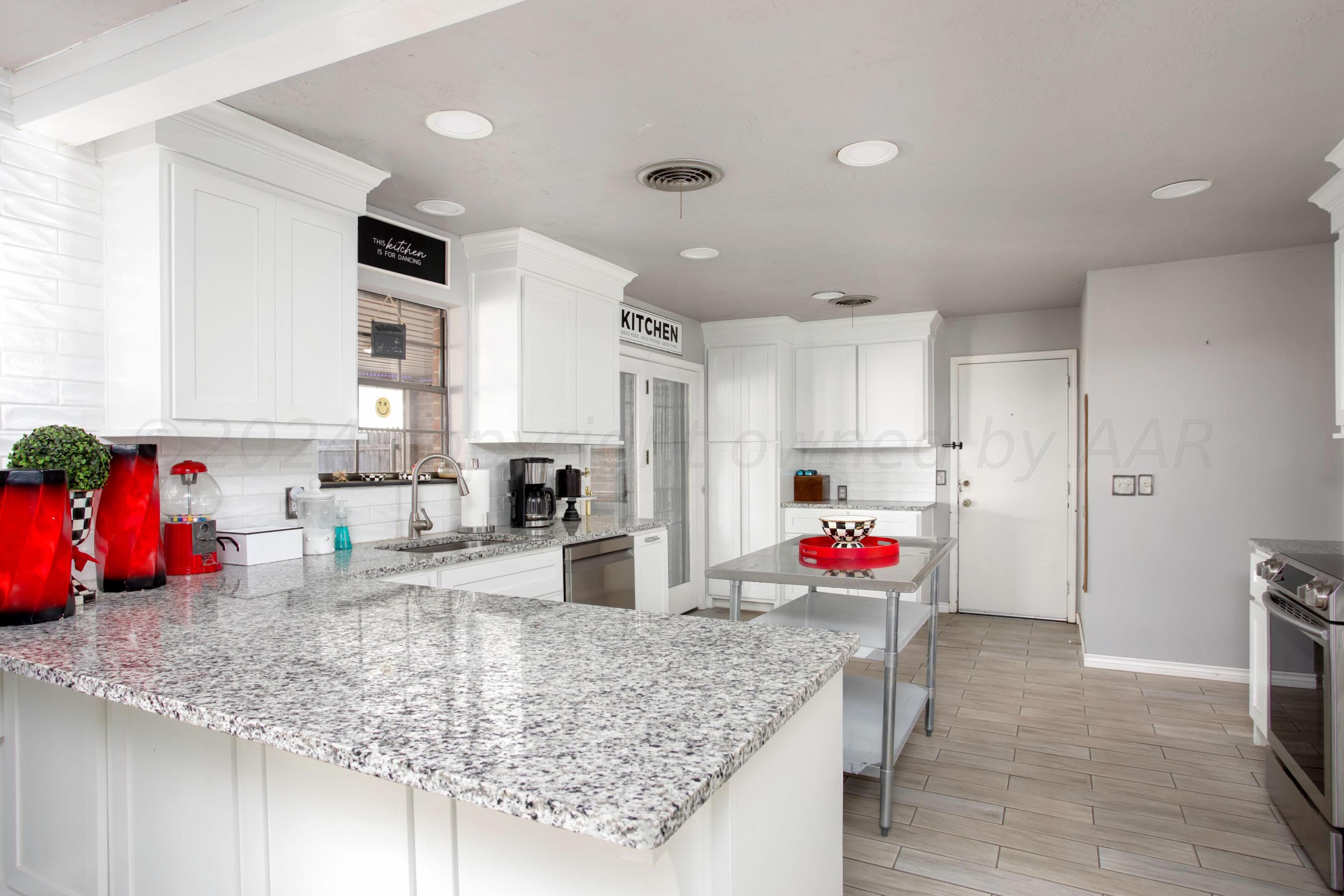 a kitchen with counter top space cabinets and stainless steel appliances