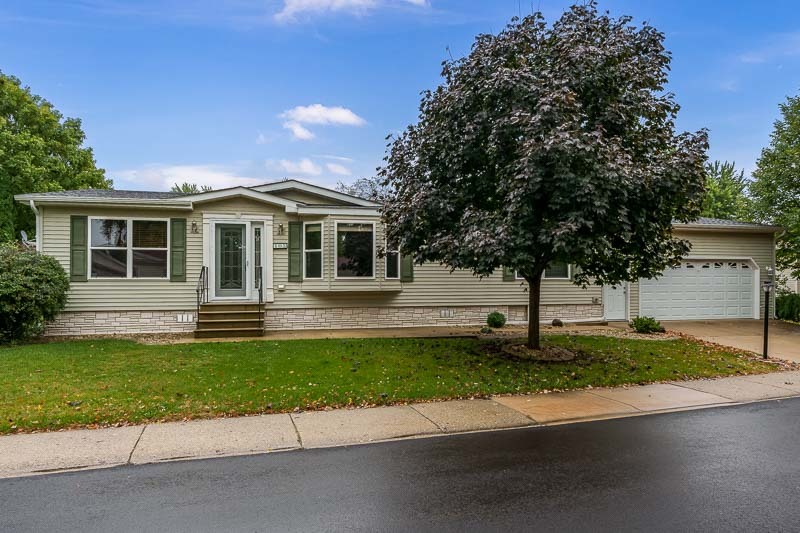 a front view of a house with a garden and yard