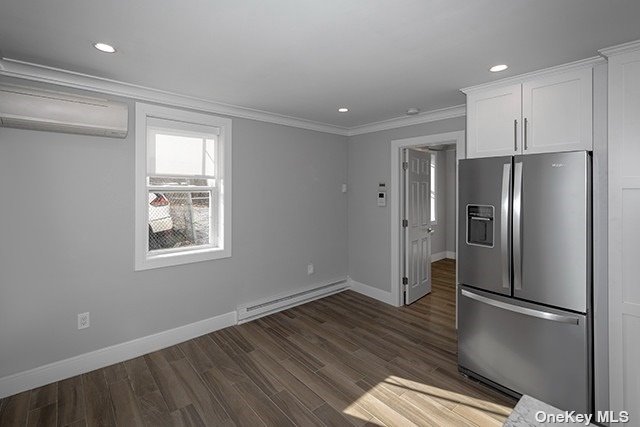 a kitchen with stainless steel appliances a refrigerator and wooden floor