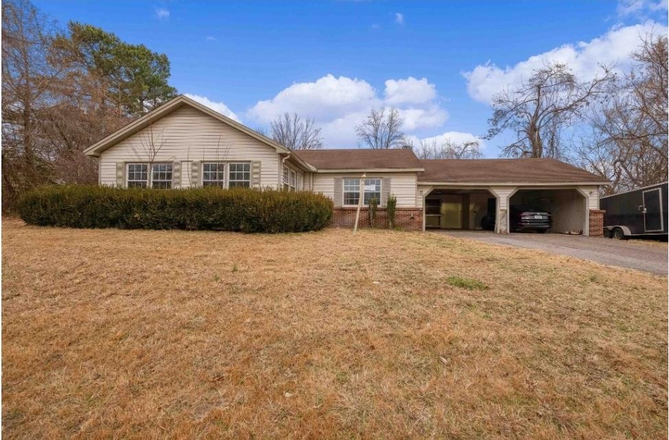 a front view of a house with yard and green space