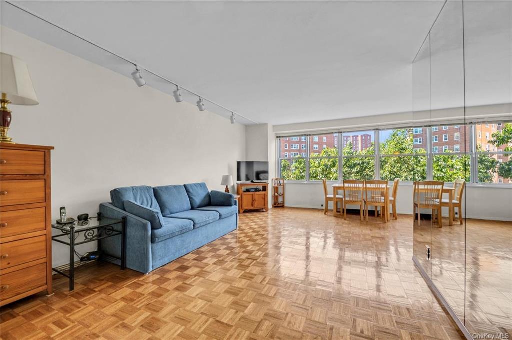 Living room with light parquet flooring and track lighting