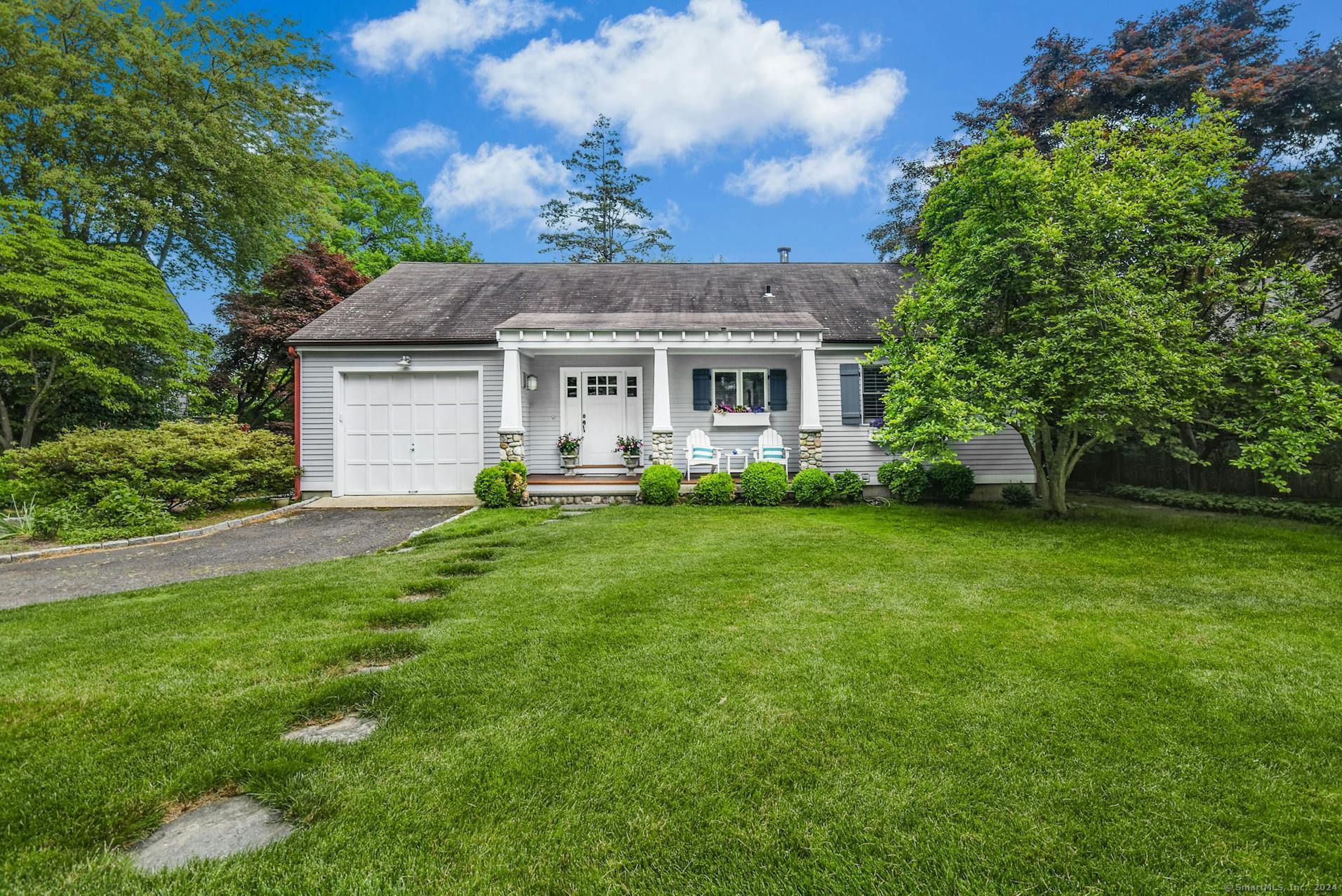 a front view of house with yard and green space