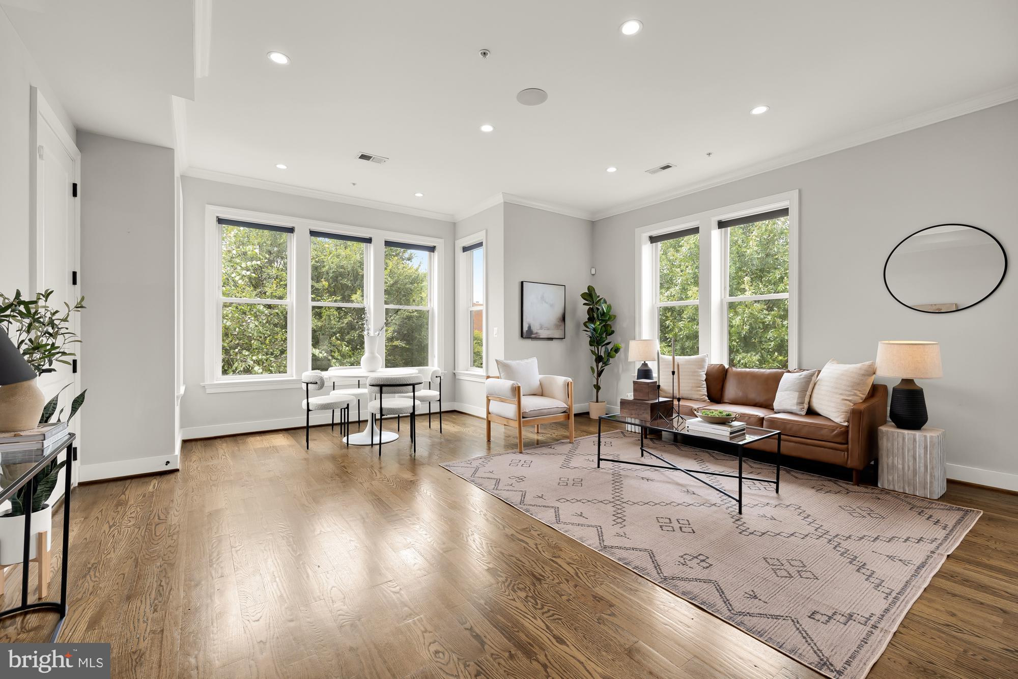 a living room with furniture and large windows