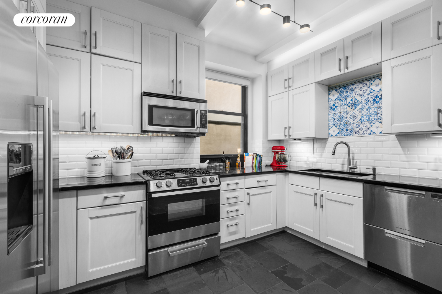 a kitchen with granite countertop white cabinets stainless steel appliances and sink