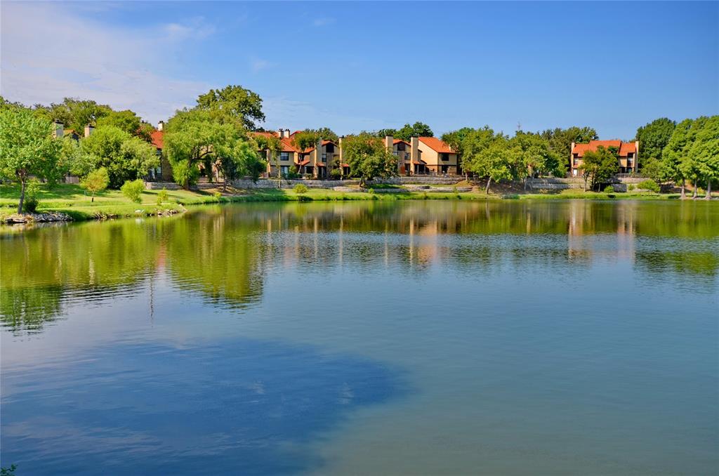 a view of a lake with houses in the back