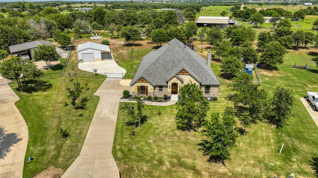 an aerial view of a house with swimming pool outdoor seating and yard