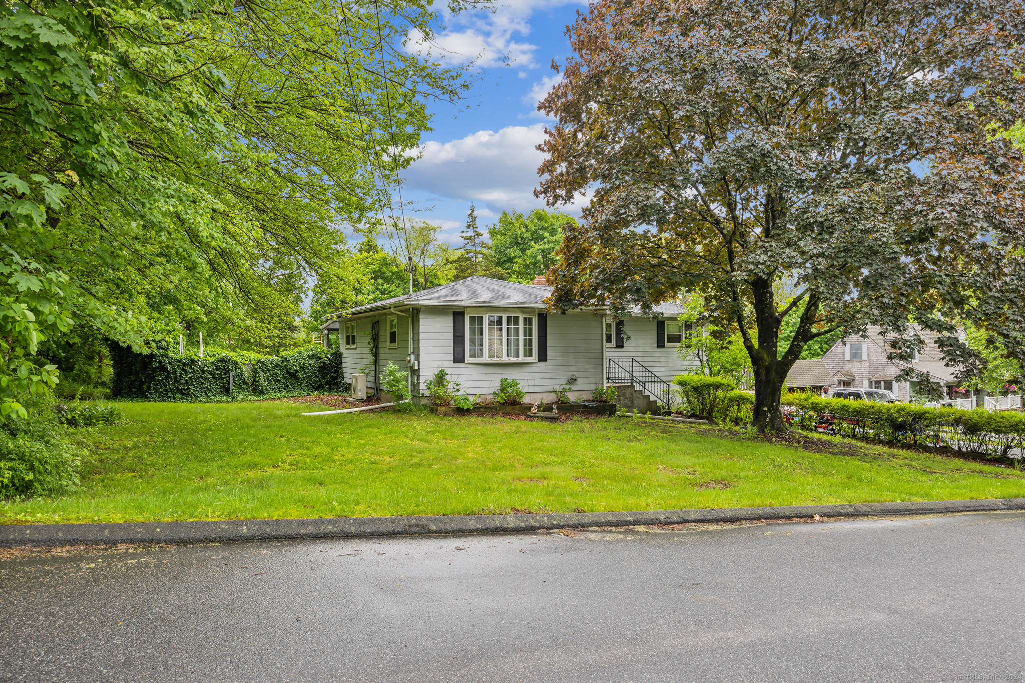 a house with a big yard and large trees