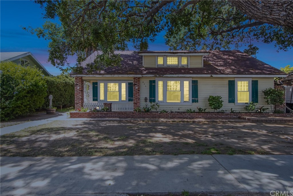 a front view of house with a garden