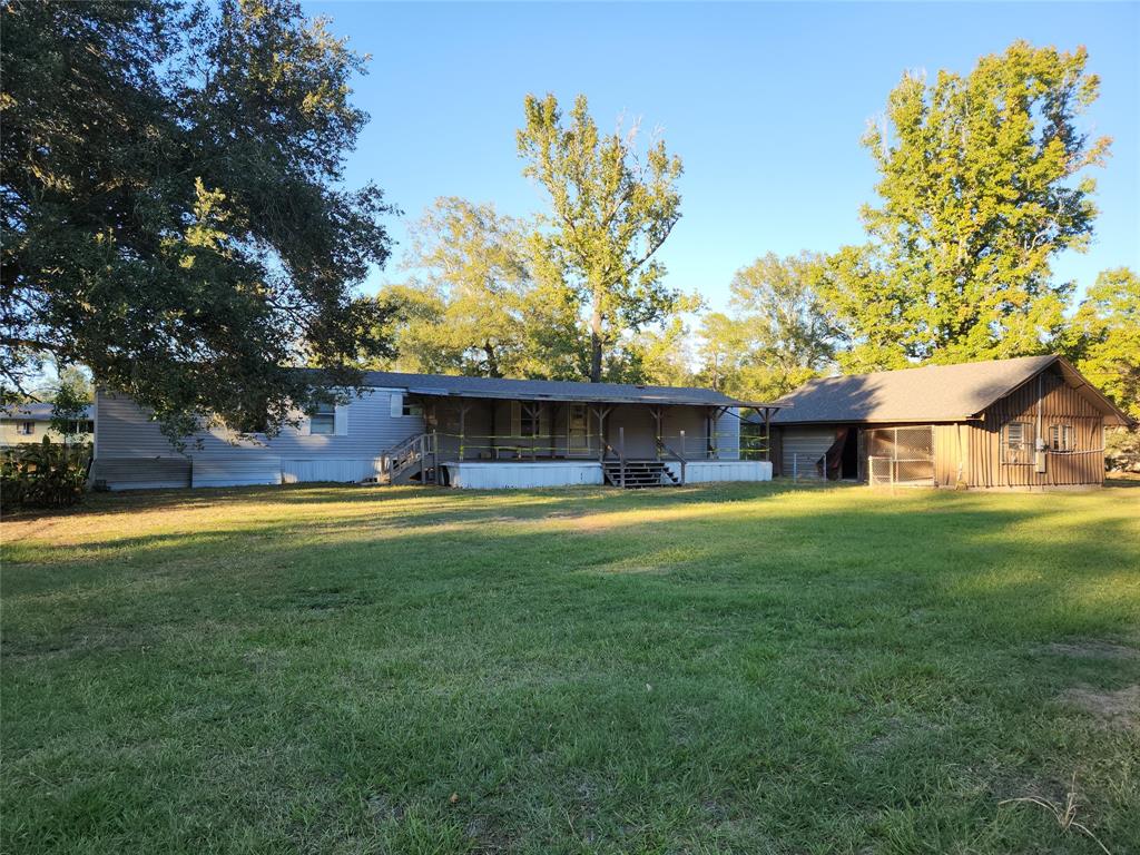 a view of house with outdoor space and yard