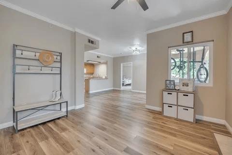 a view of a kitchen with wooden floor and electronic appliances