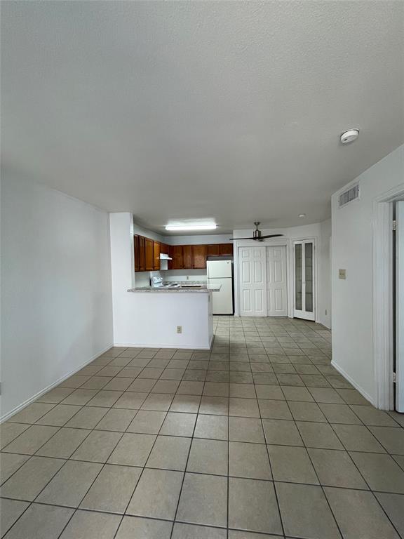 a view of a kitchen with a sink and a refrigerator cabinets