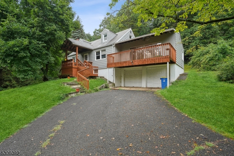 a front view of a house with a garden and plants