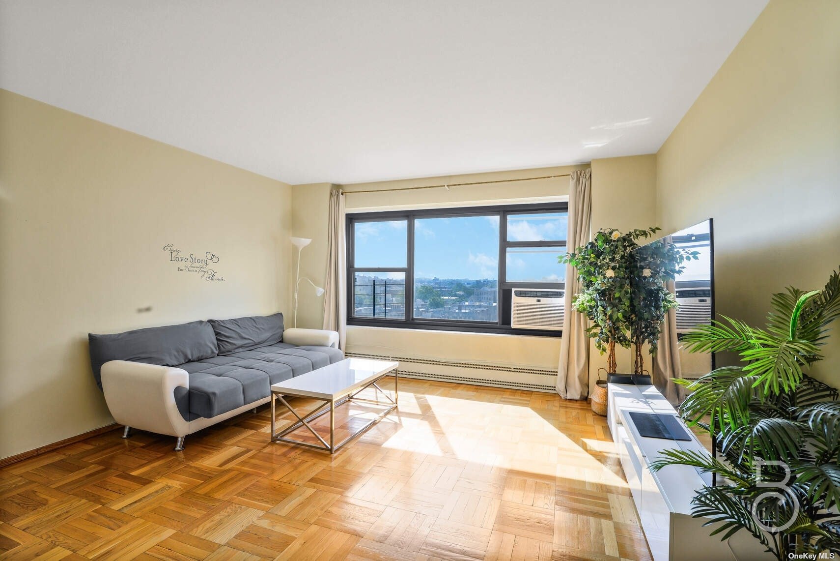 a living room with furniture and a large window